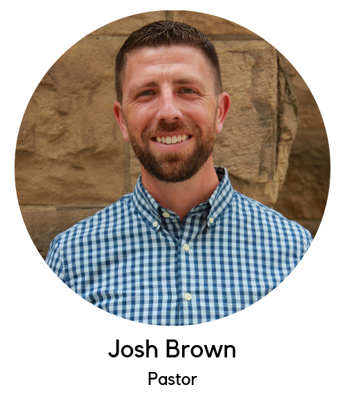 Josh Brown, Pastor. White man with light brown hair, brown full beard, blue and white checkered button up shirt