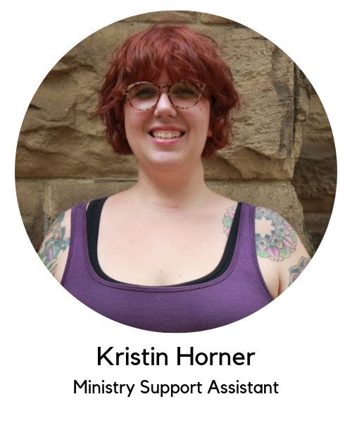 Kristin Horner, ministry support assistant. White woman with red hair and glasses wearing a purple tank top.